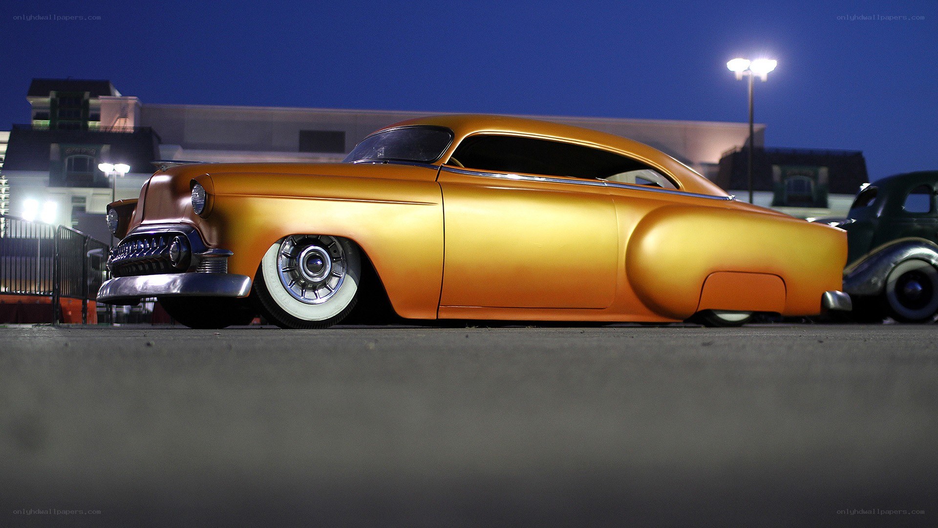 golden classic car at night