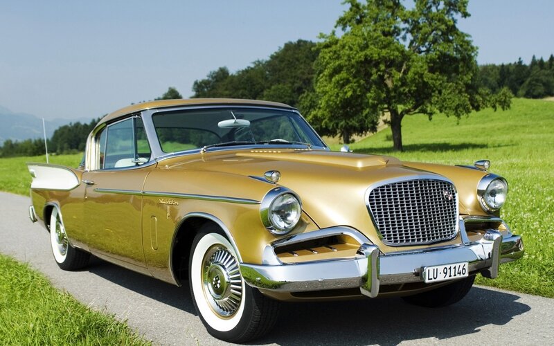Golden classic car on a country road