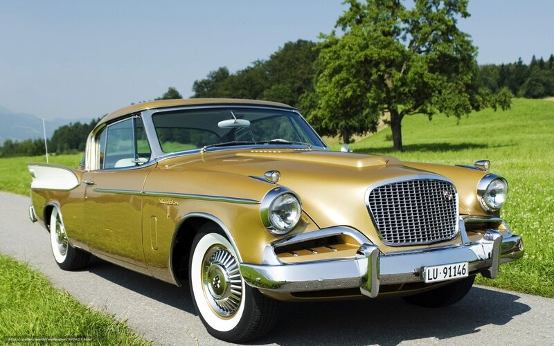 Golden classic car on a country road