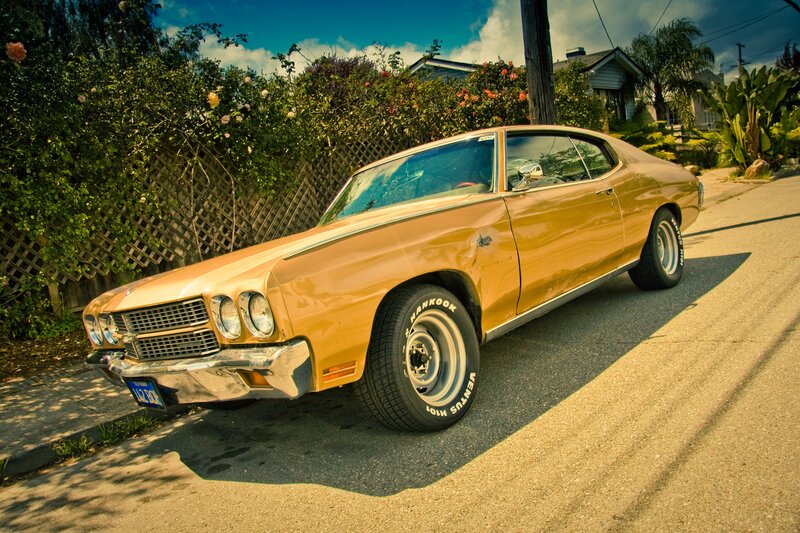 Golden classic muscle car on street