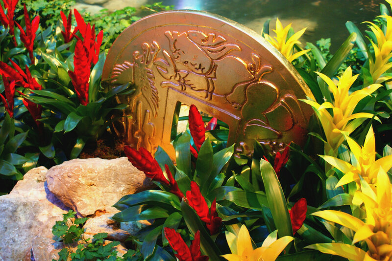 Golden coin sculpture in garden