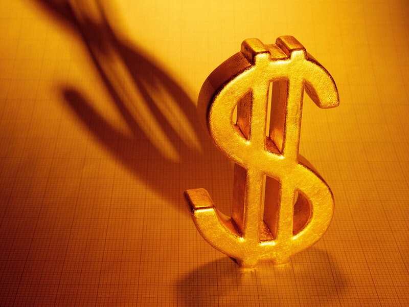 golden dollar sign on graph paper