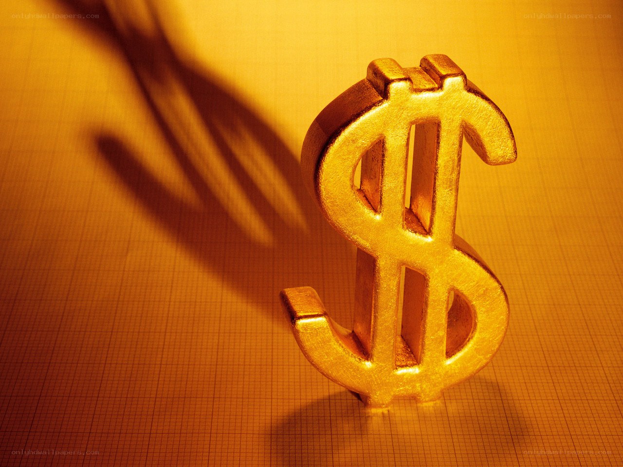 golden dollar sign on graph paper