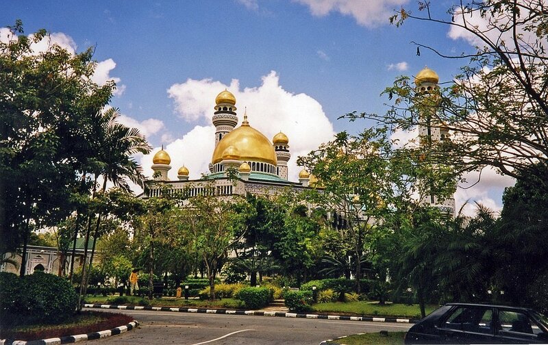 Golden-domed mosque in a tropical setting