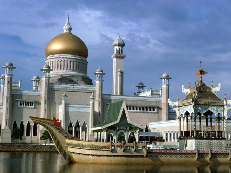 Golden-domed mosque with boat sculpture