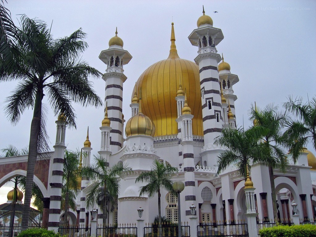 golden-domed mosque with palm trees