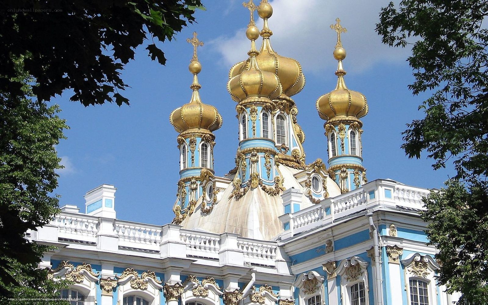Golden domes of a blue church