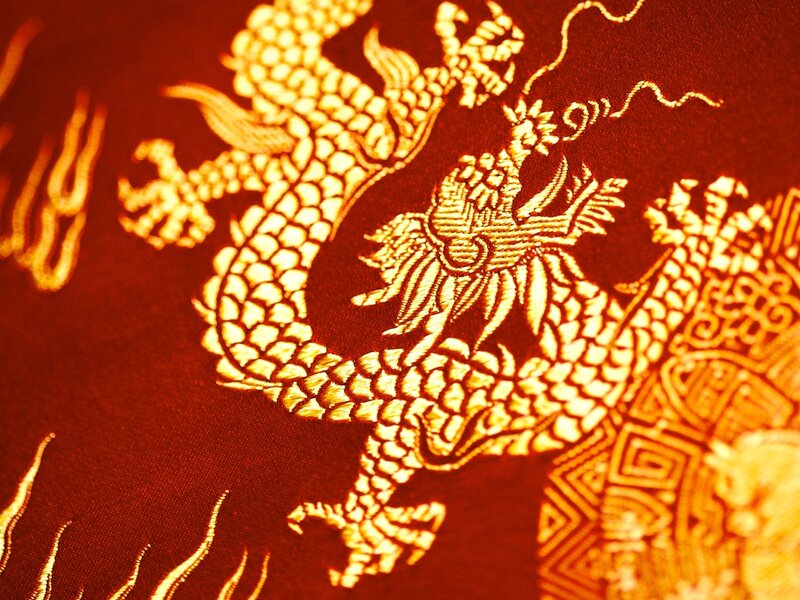 Golden dragon embroidery on red fabric