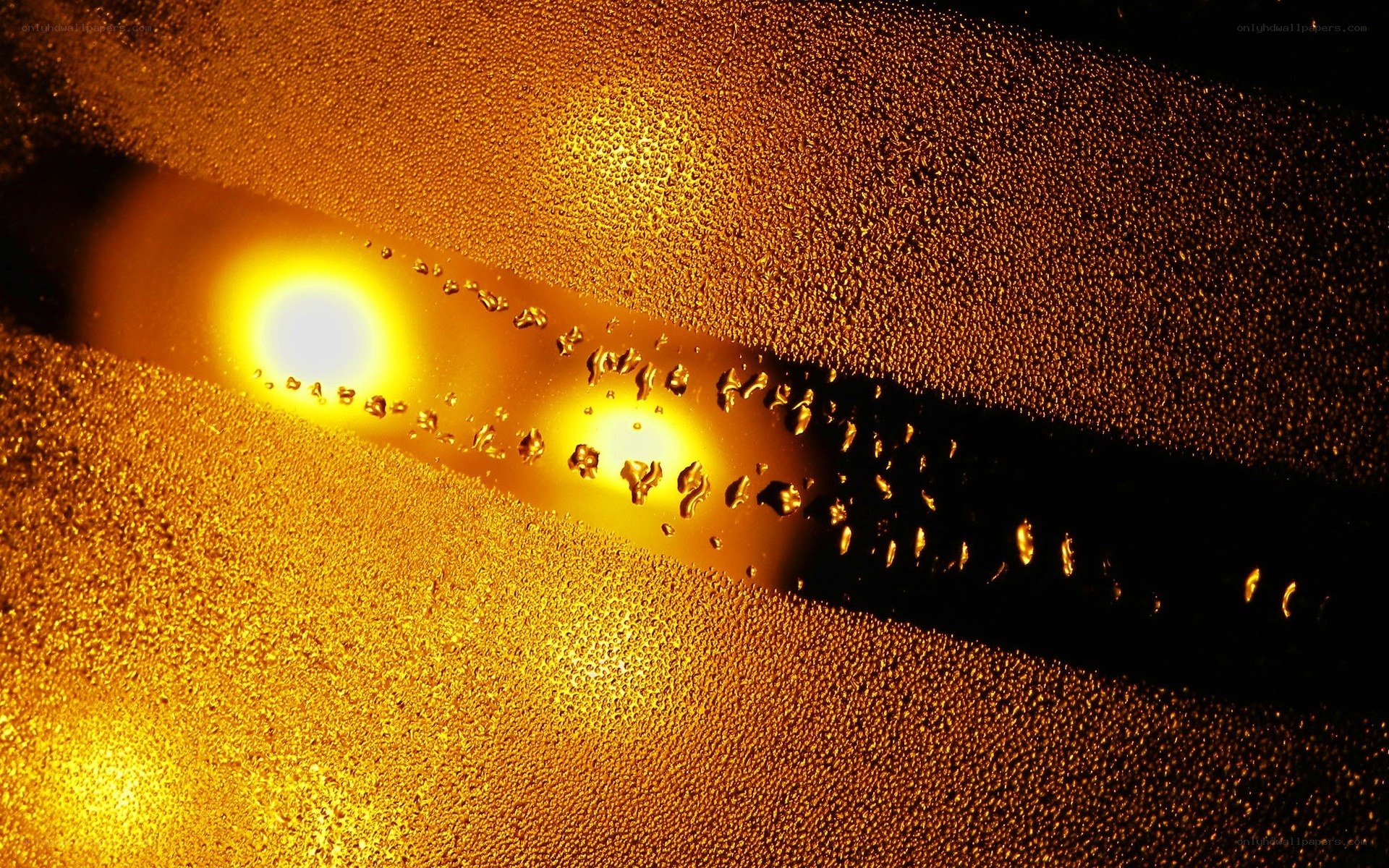 golden droplets on glass