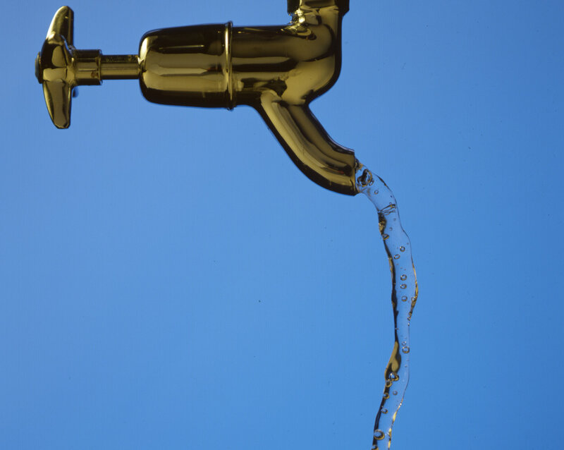 golden faucet with flowing water
