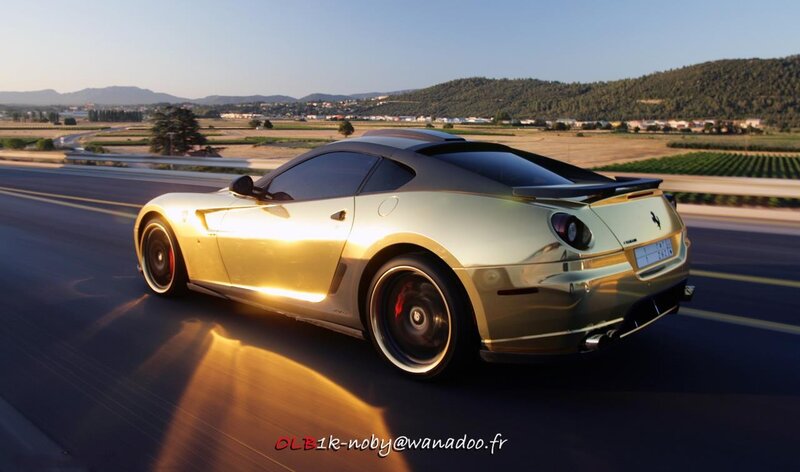 Golden Ferrari on a scenic road