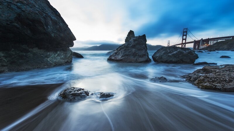 Golden Gate Bridge at Dusk — Blue, Serene, Sunset, Photograph, Rocks