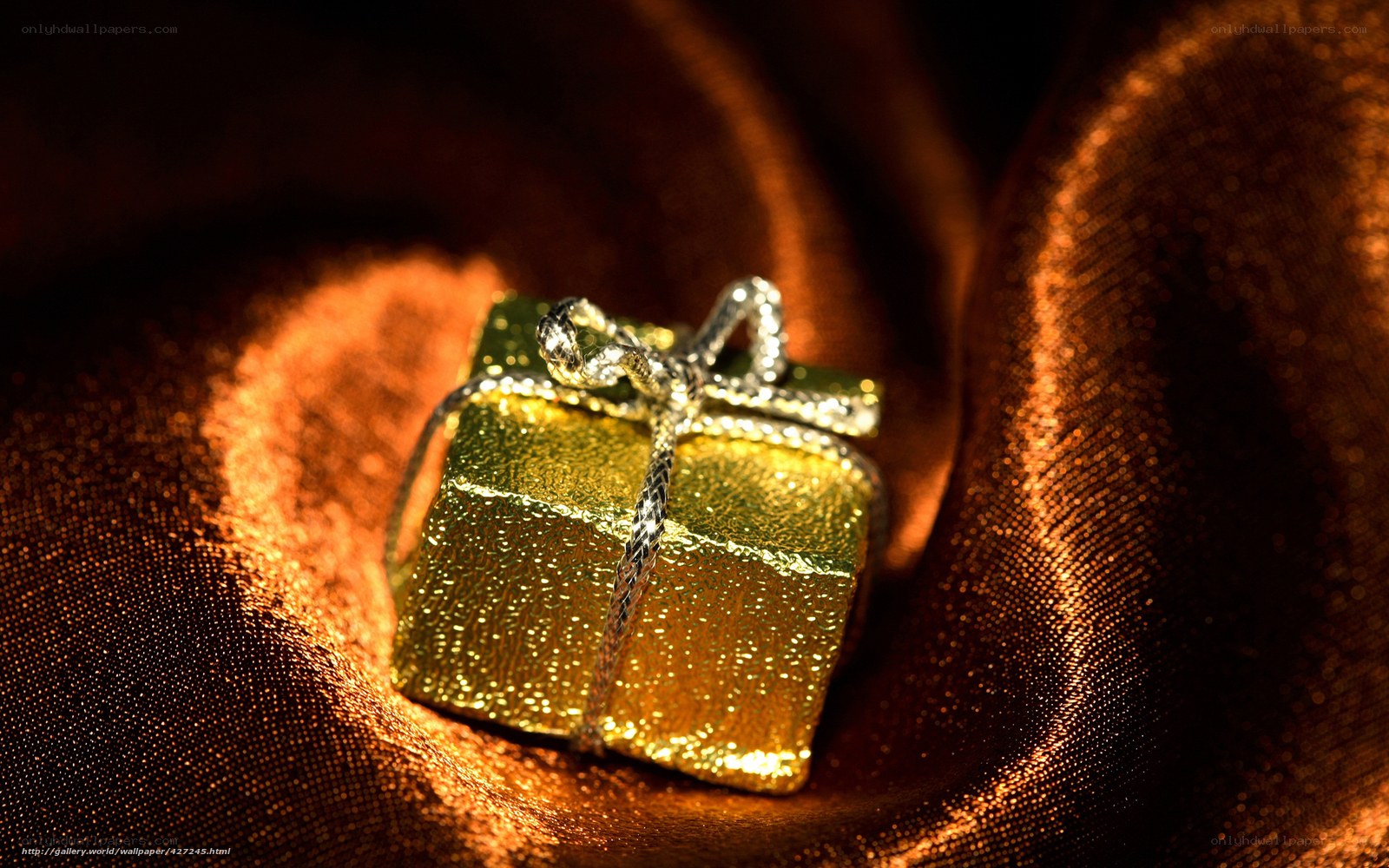 Golden gift box on fabric