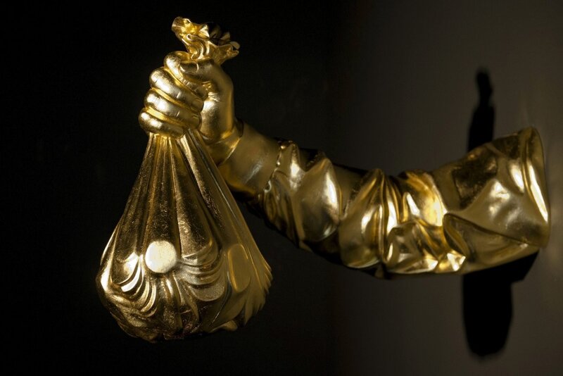 Golden hand holding money bag