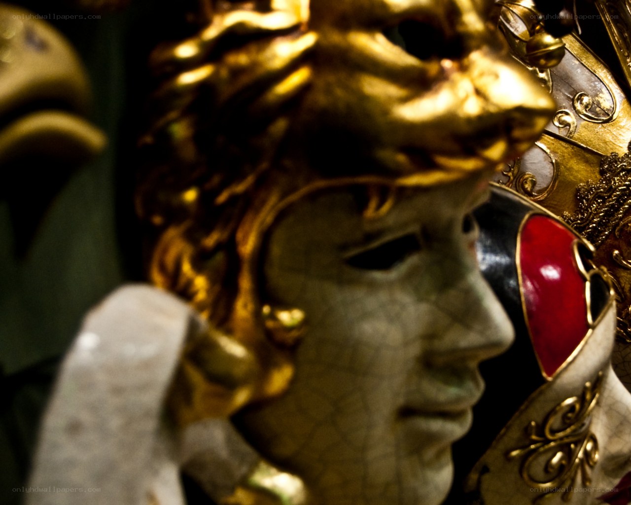 golden mask with red gem