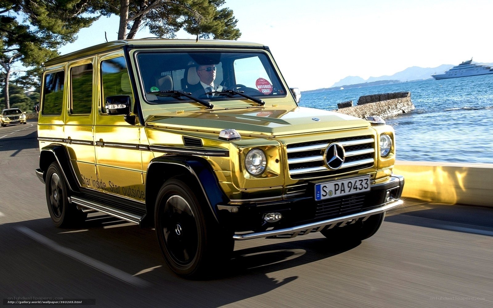 Golden Mercedes G-Wagon on coastal road
