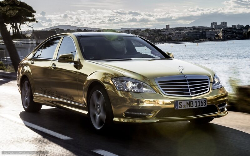 golden mercedes on coastal road