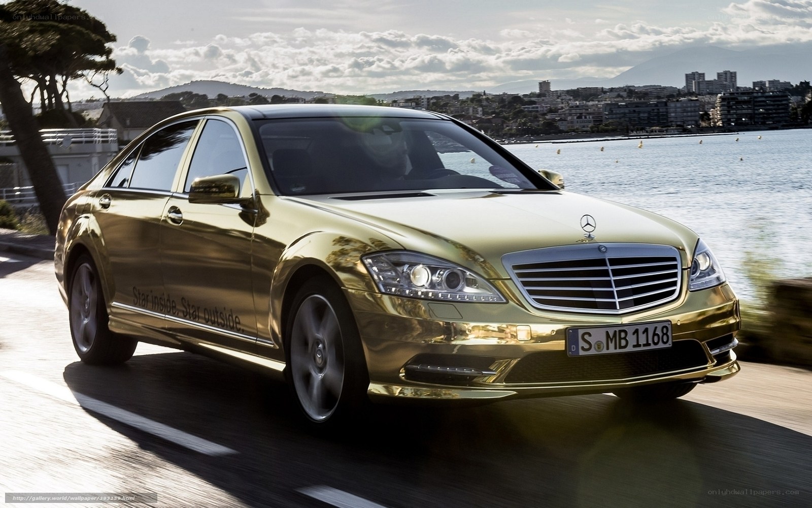 golden mercedes on coastal road