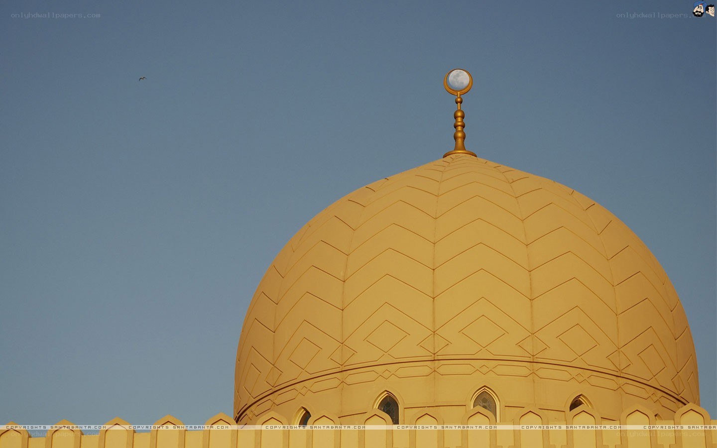 golden mosque dome against blue sky