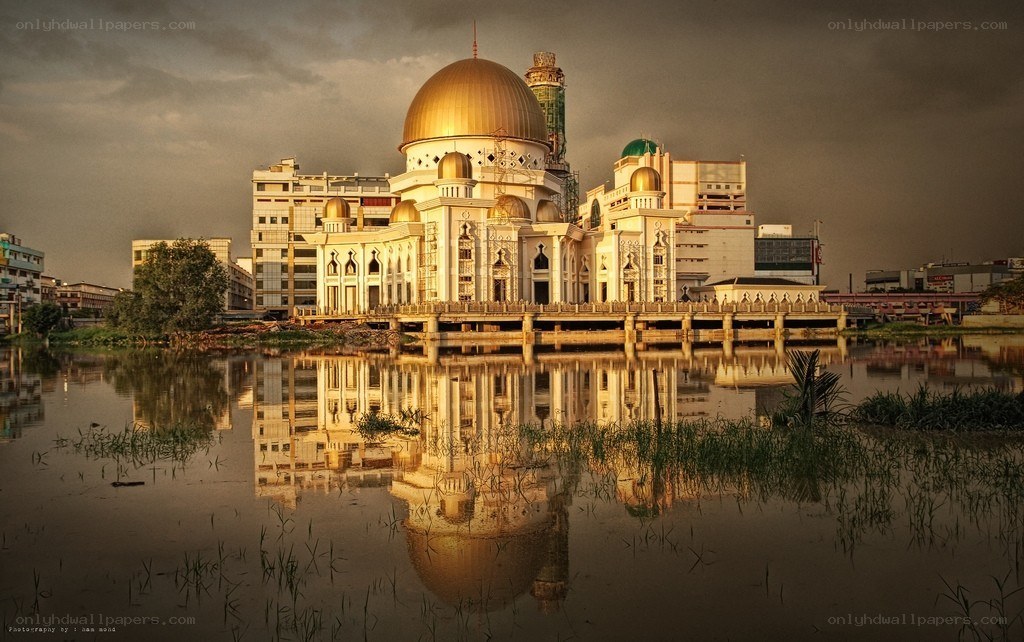 Golden mosque reflected in water