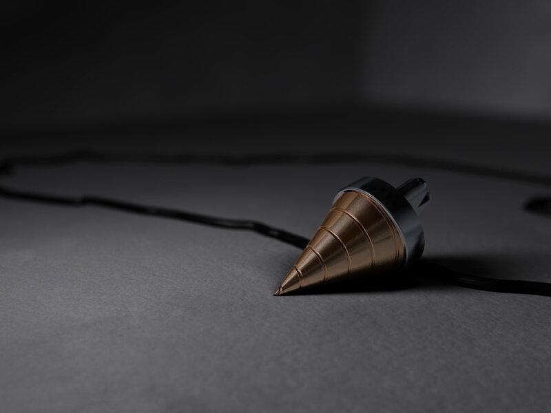 golden pendulum on dark surface
