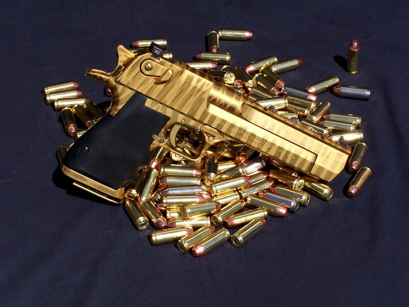 Golden pistol with ammunition