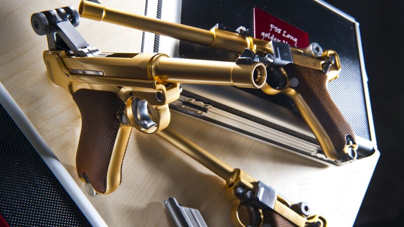 Golden pistols in display case