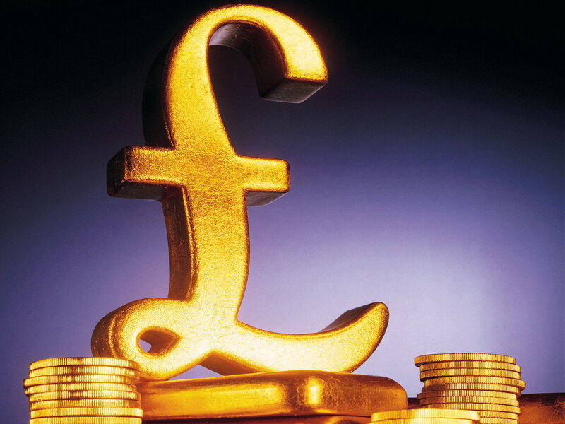 Golden pound symbol with coins
