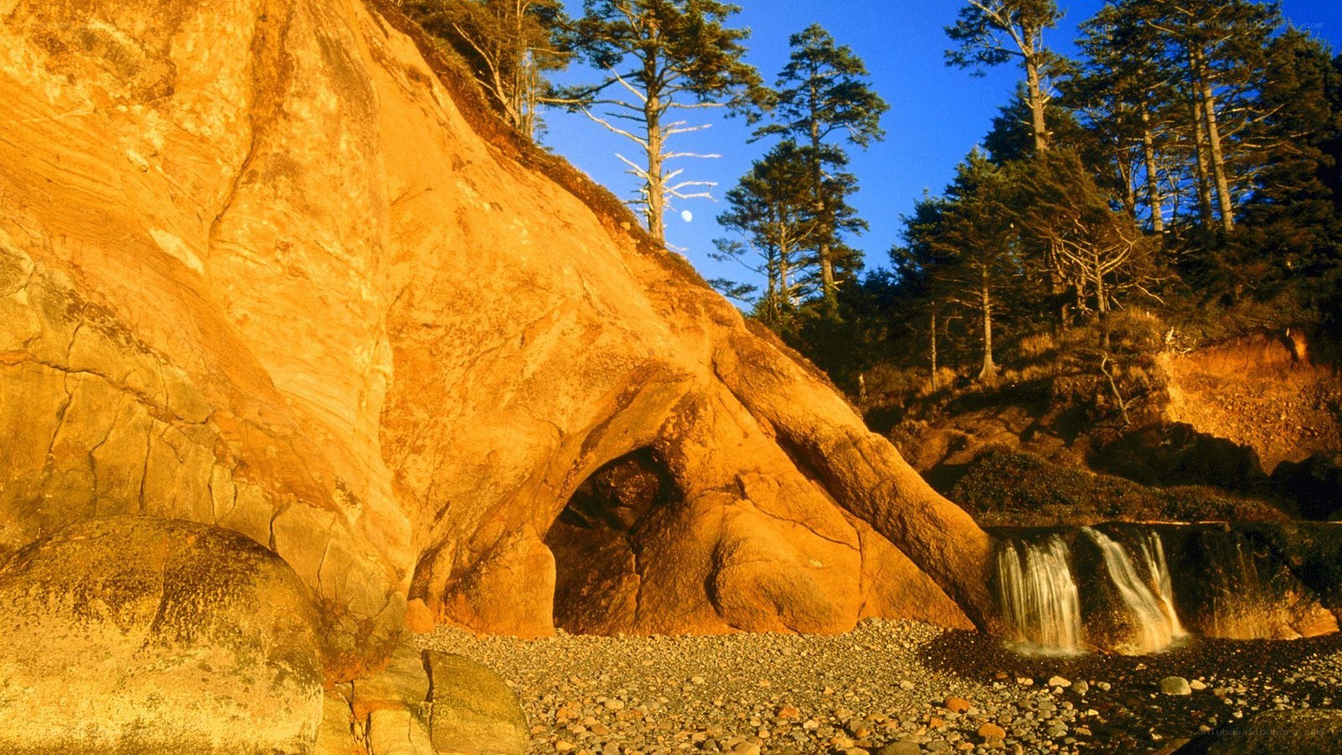 Golden rock formation with waterfall