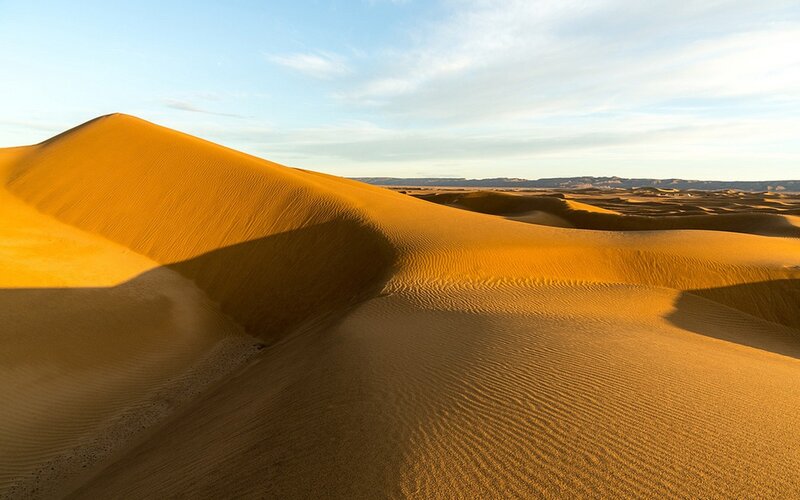 Golden sand dunes at sunset