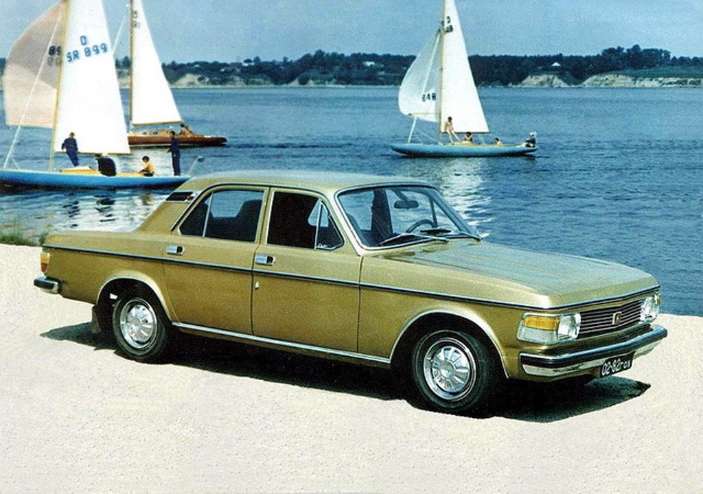 Golden sedan by the water