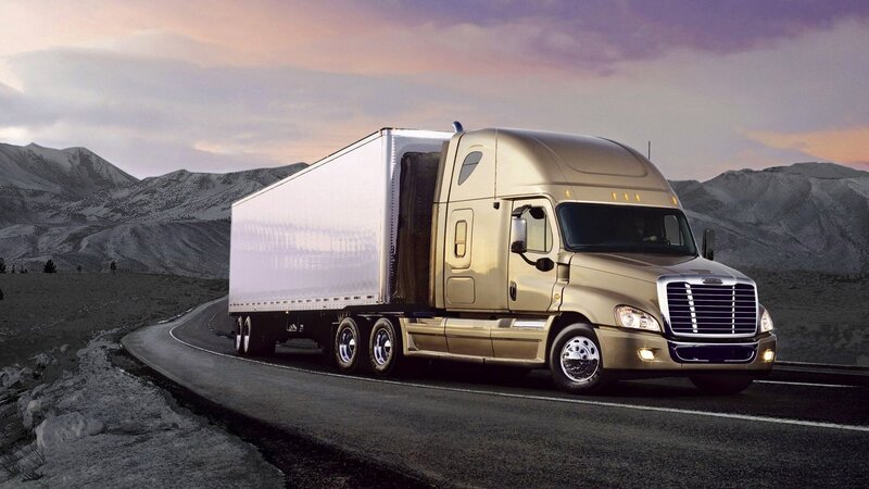 golden semi-truck on mountain road