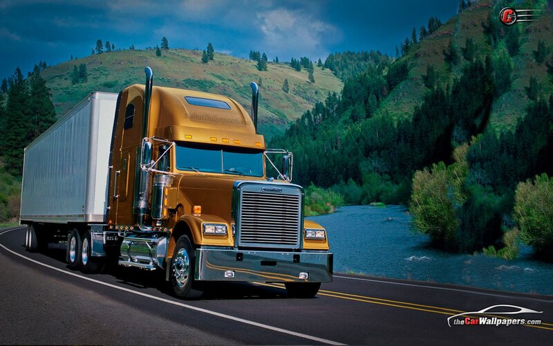 golden semi-truck on scenic road