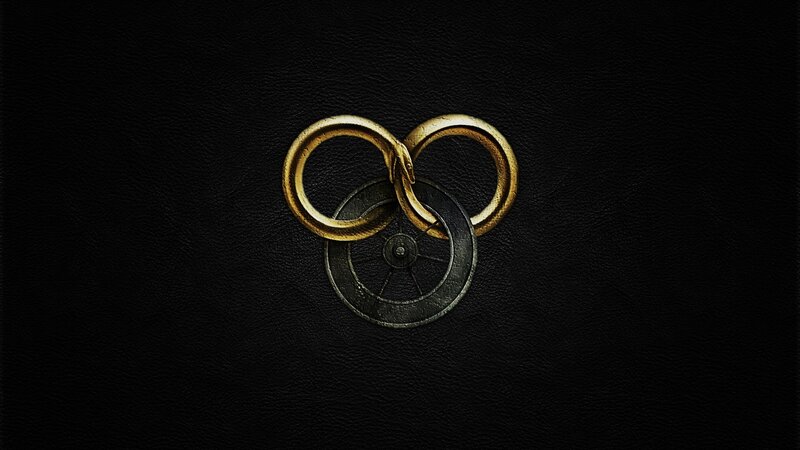 golden serpent rings on black leather