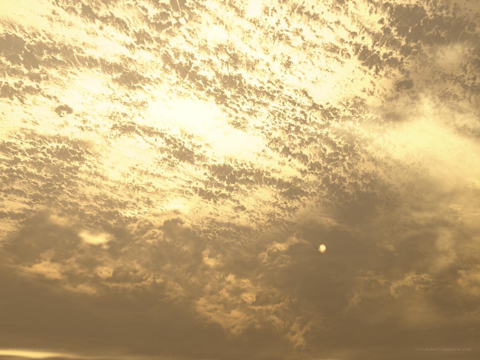 Golden sky with scattered clouds