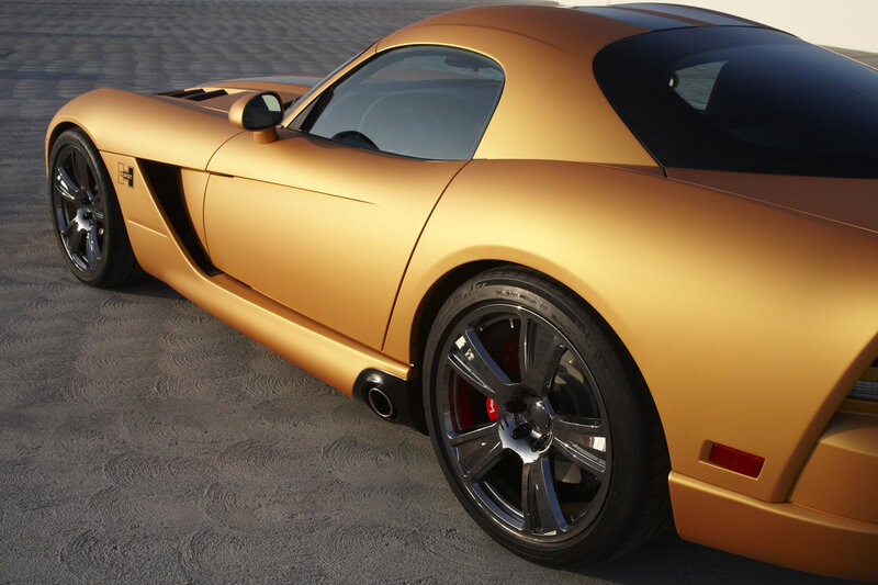 golden sports car on pavement