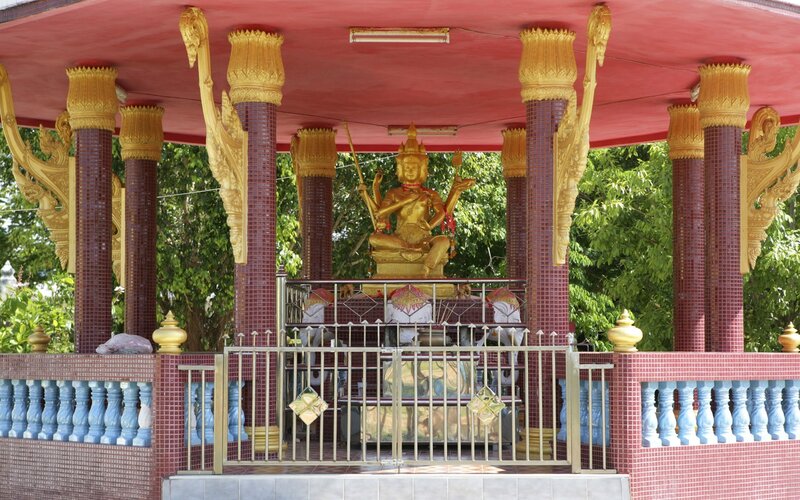 Golden statue in temple pavilion