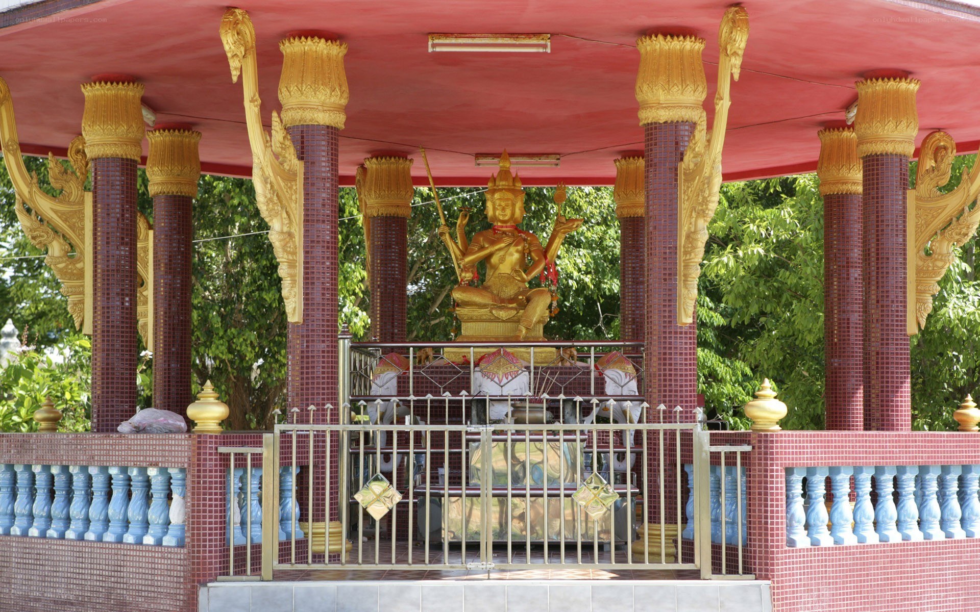 Golden statue in temple pavilion