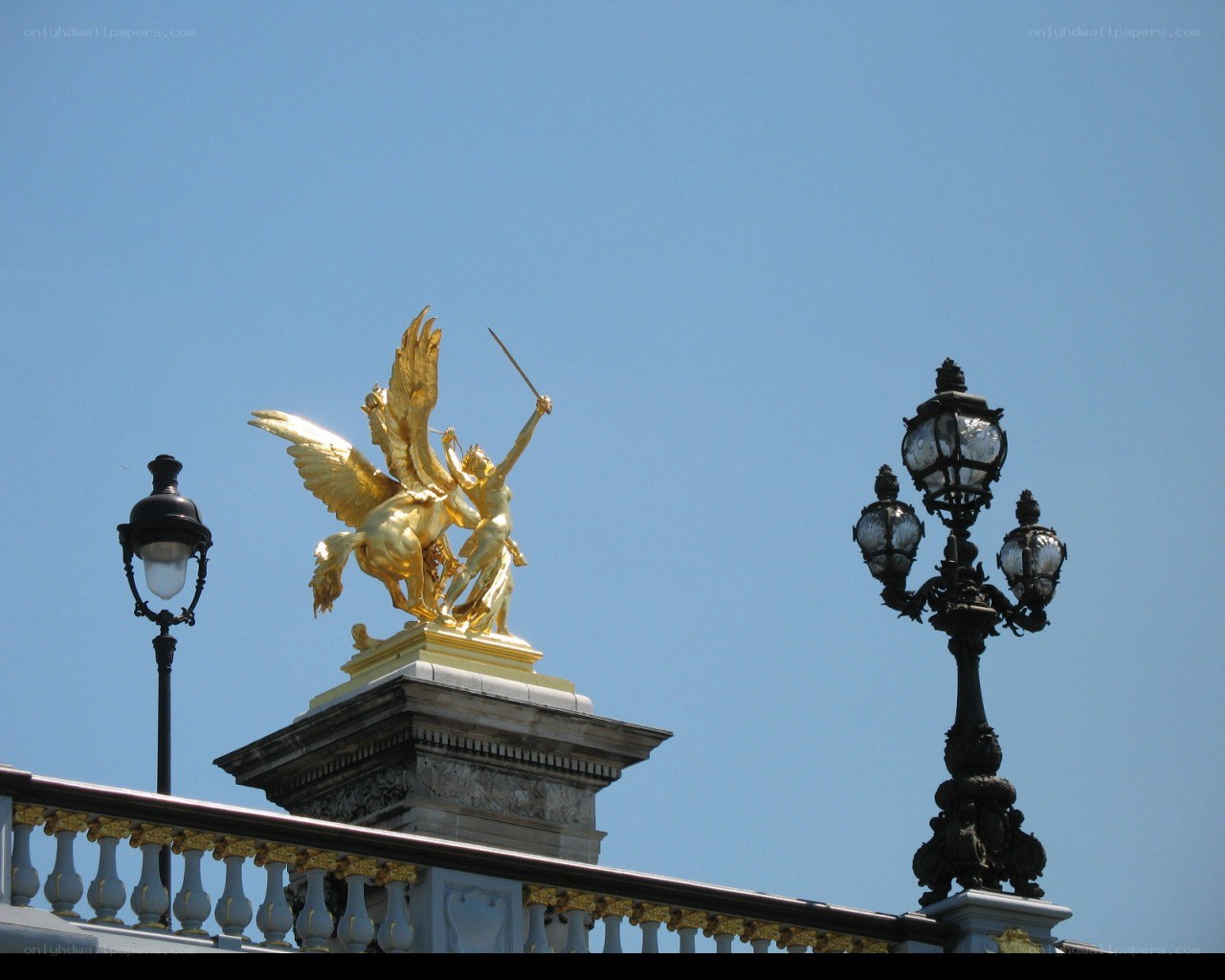 Golden statue on a bridge