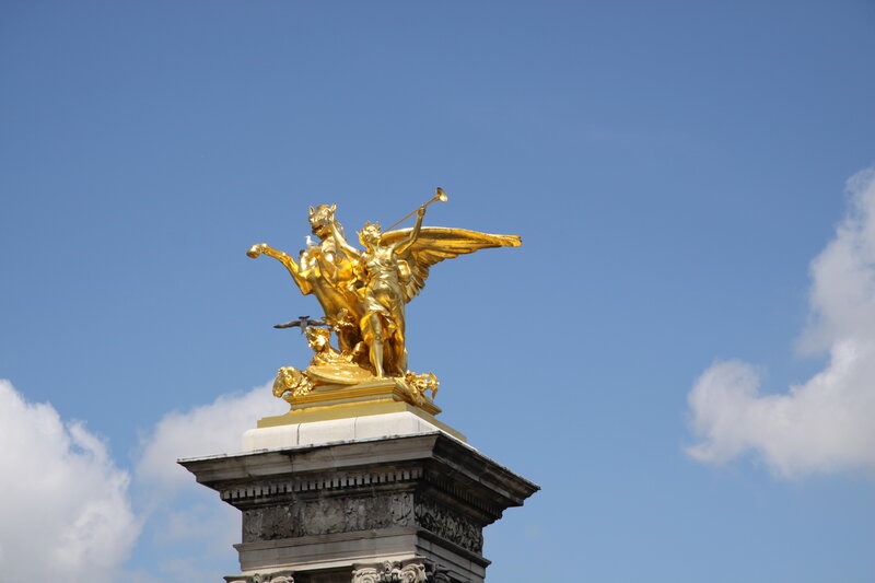 Golden Statue on Pedestal