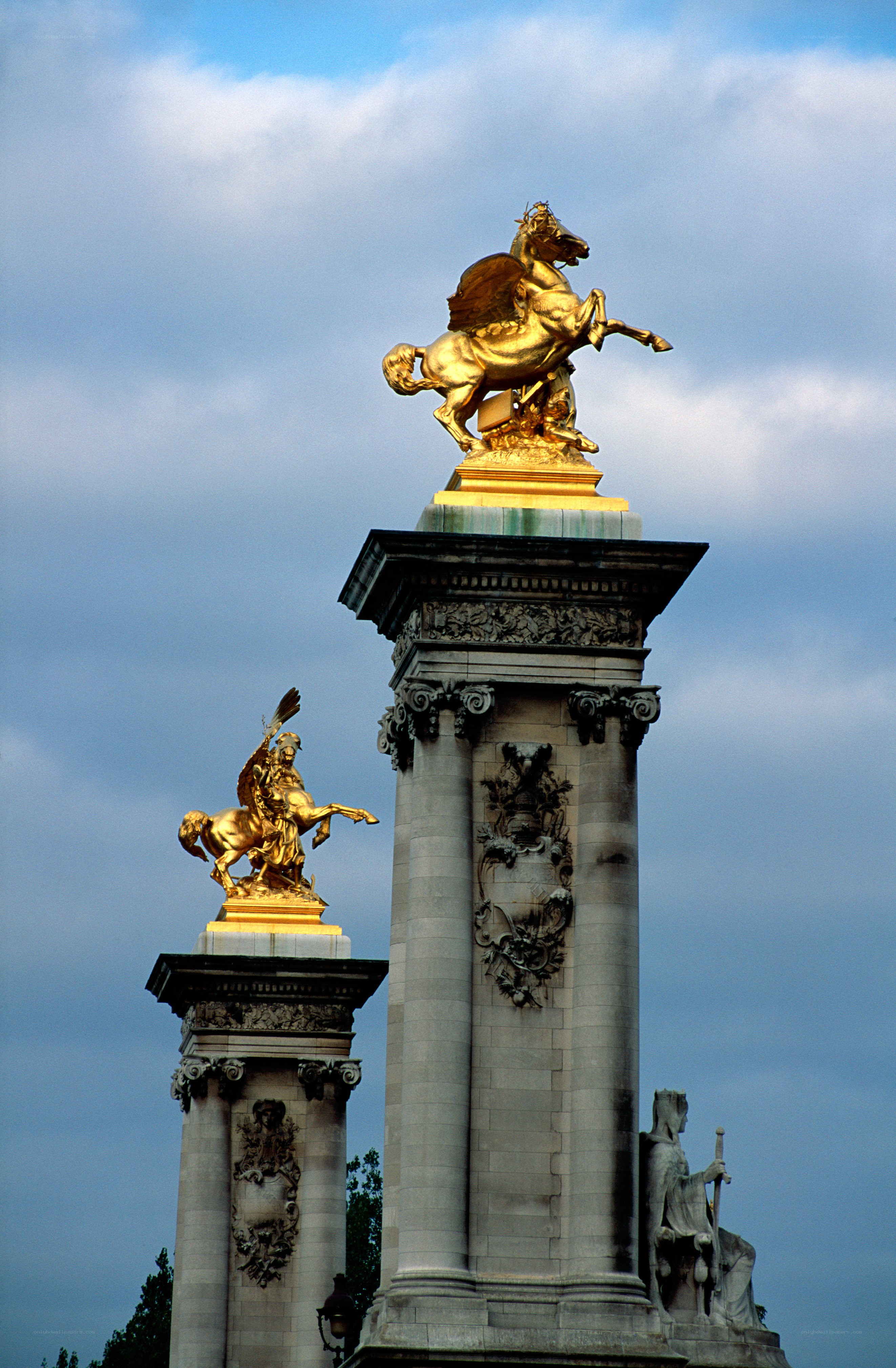 Golden statues on a bridge
