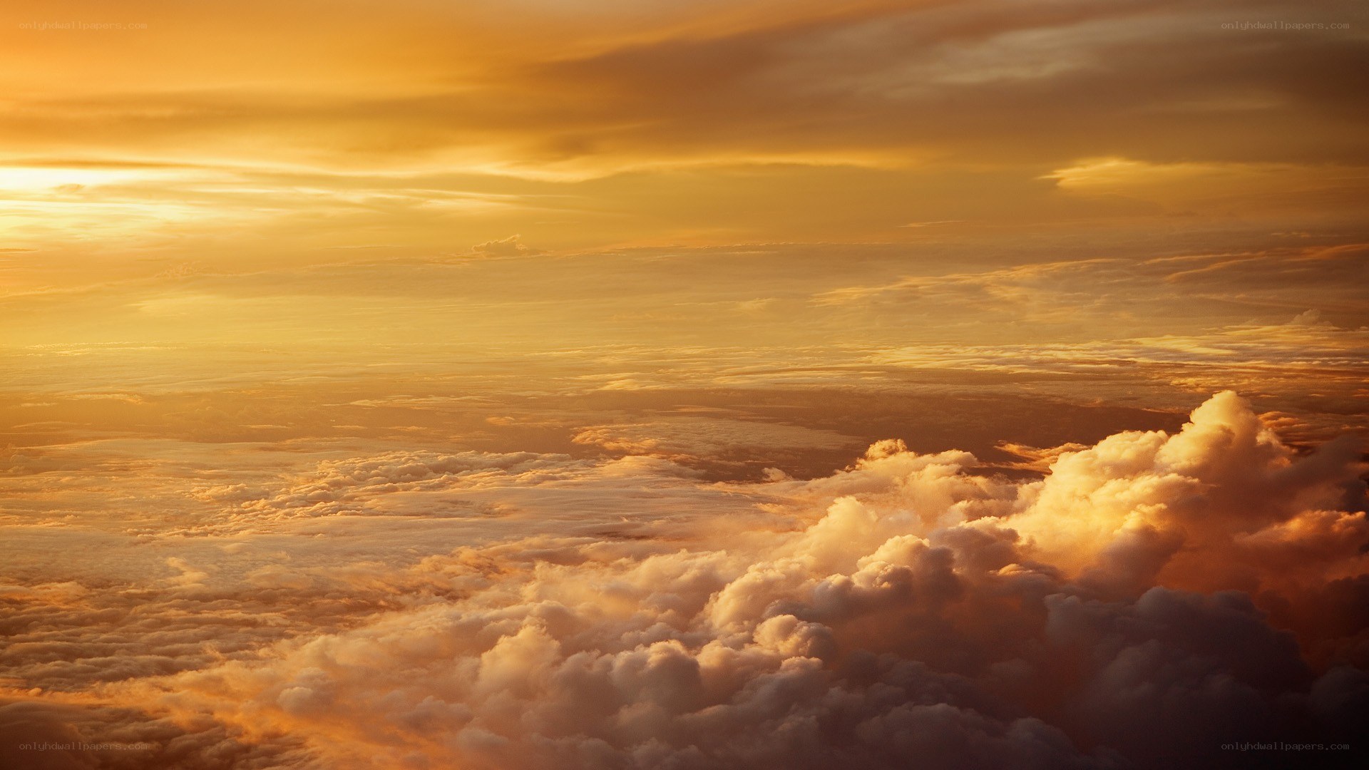 Golden sunset above clouds