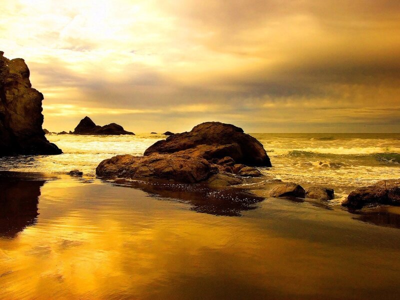Golden sunset at rocky beach