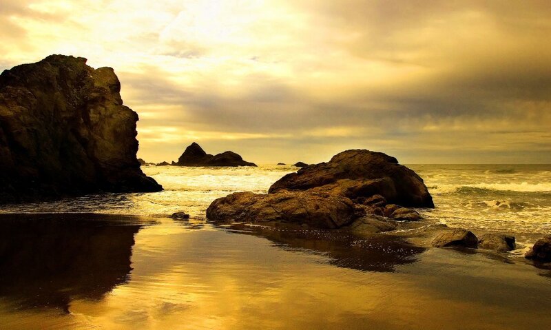 Golden sunset at rocky beach