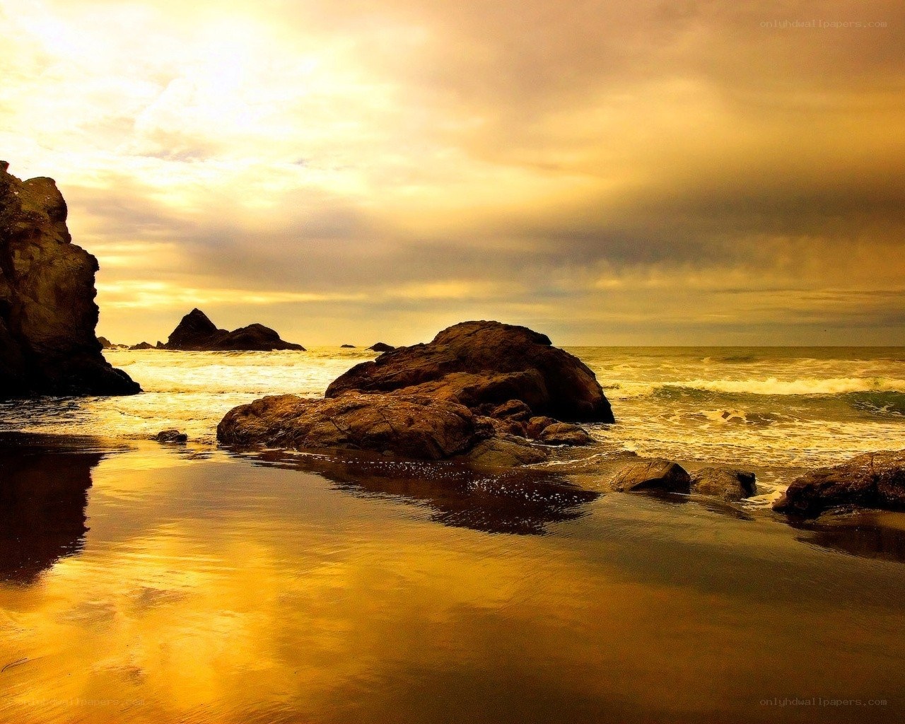 Golden sunset at rocky beach