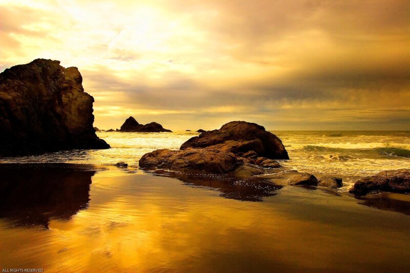 Golden sunset at the rocky beach