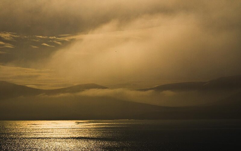 Golden sunset over misty mountains
