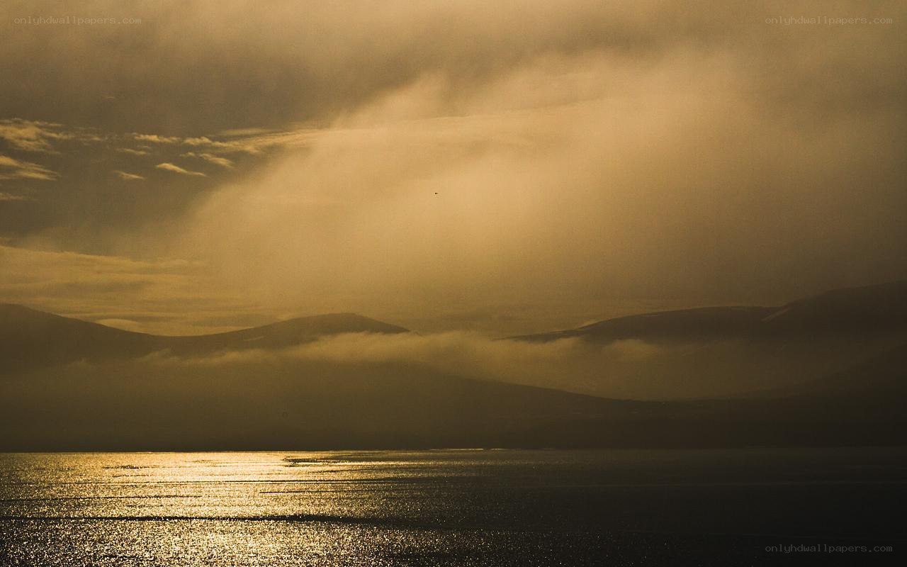 Golden sunset over misty mountains