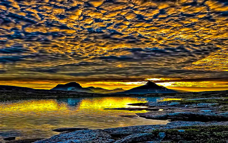 Golden sunset over mountain lake