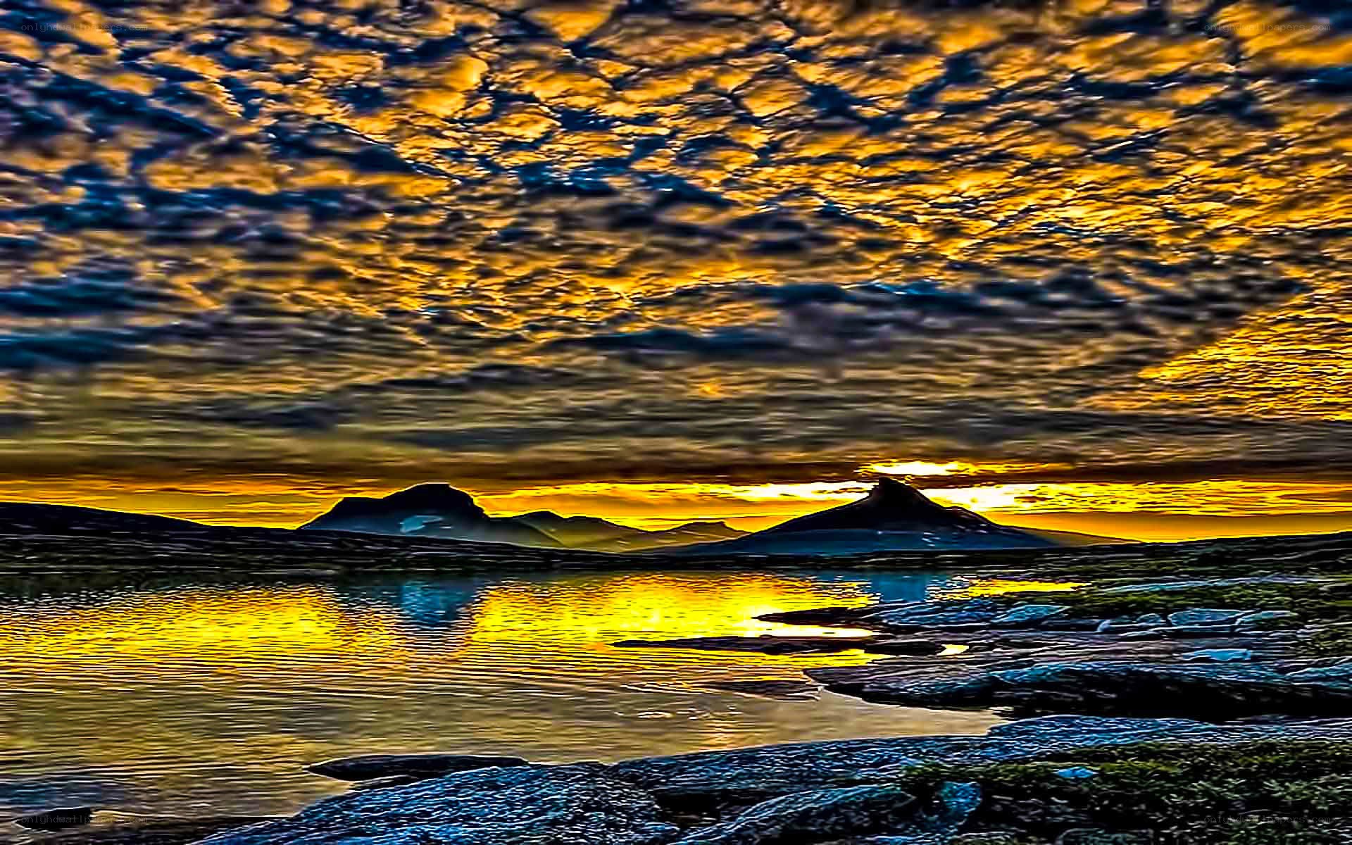 Golden sunset over mountain lake